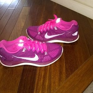 Magenta and pink Nike cross trainers.